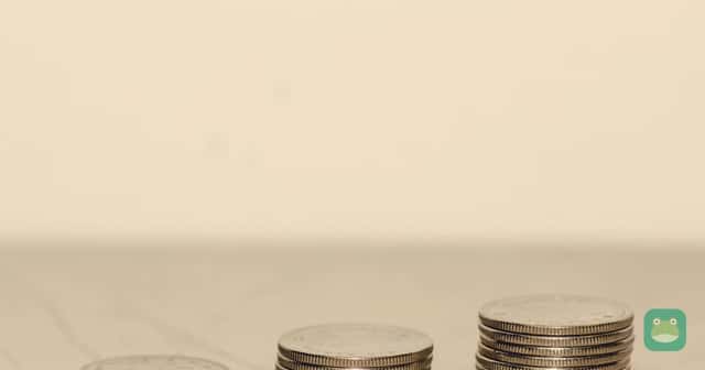 Three stacks of Canadian 25-cent coins, holding three, six and nine coins.
