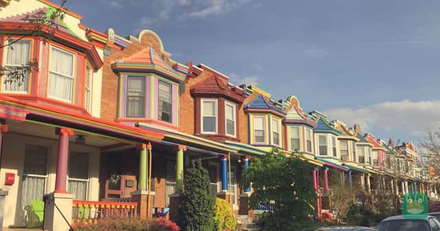 Rowhouses with front porches on Guilford Avenue in Baltimore, Maryland.