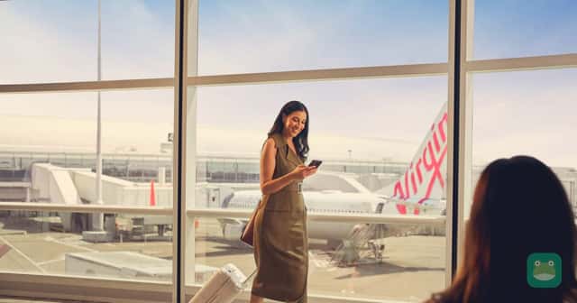 A traveler at the airport with a Virgin Australia aircraft outside